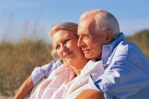 Older Couple Sitting Together at Beach